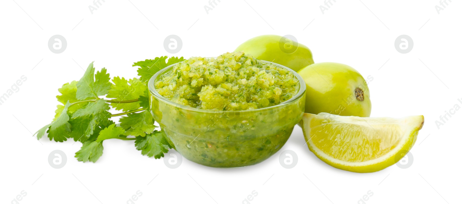 Photo of Delicious homemade green salsa and ingredients isolated on white