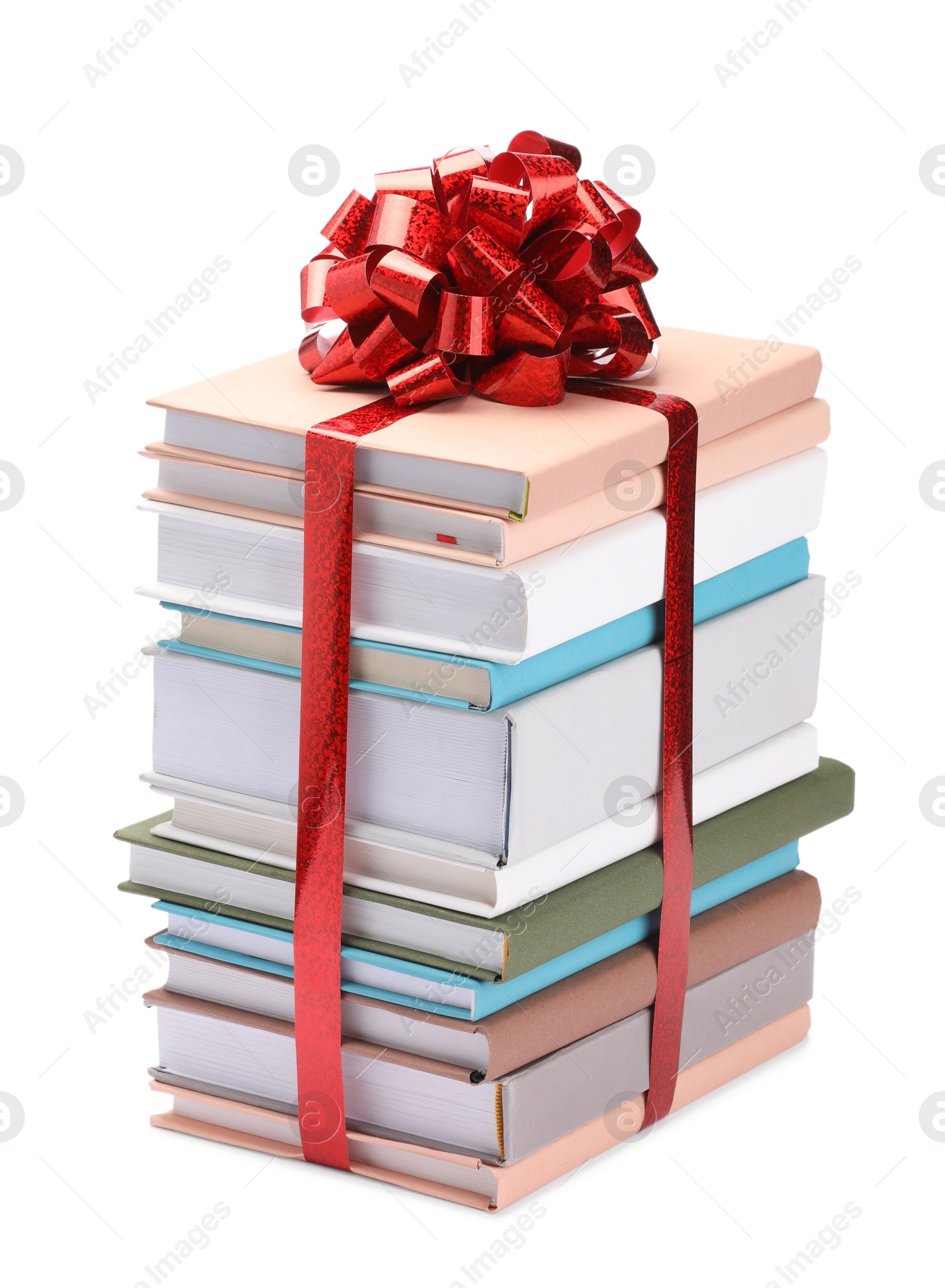 Photo of Stack of books with red bow as gift isolated on white