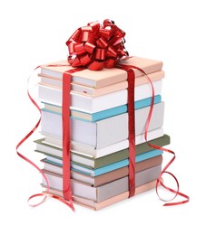 Photo of Stack of books with red bow as gift isolated on white