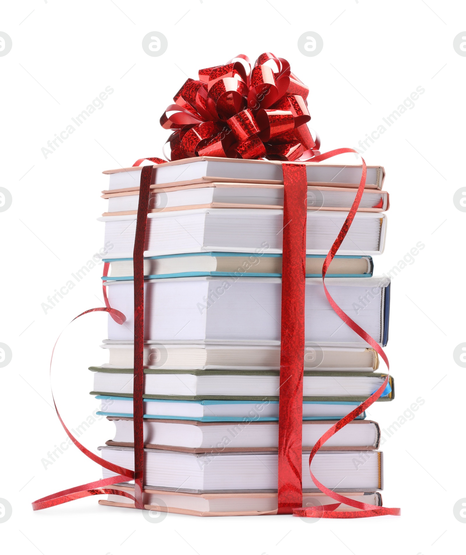 Photo of Stack of books with red bow as gift isolated on white