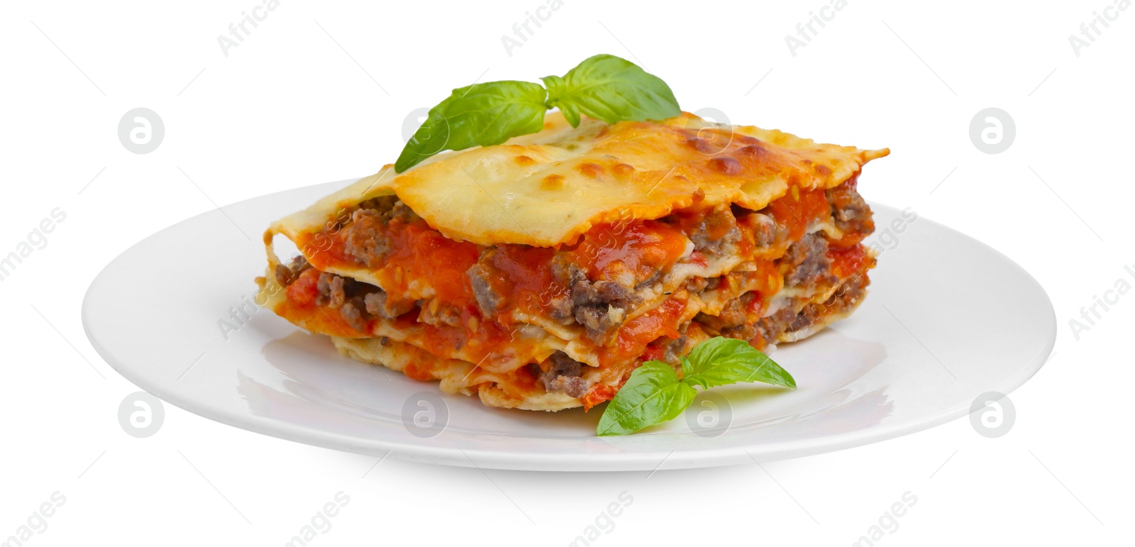 Photo of Piece of delicious cooked lasagna with basil isolated on white