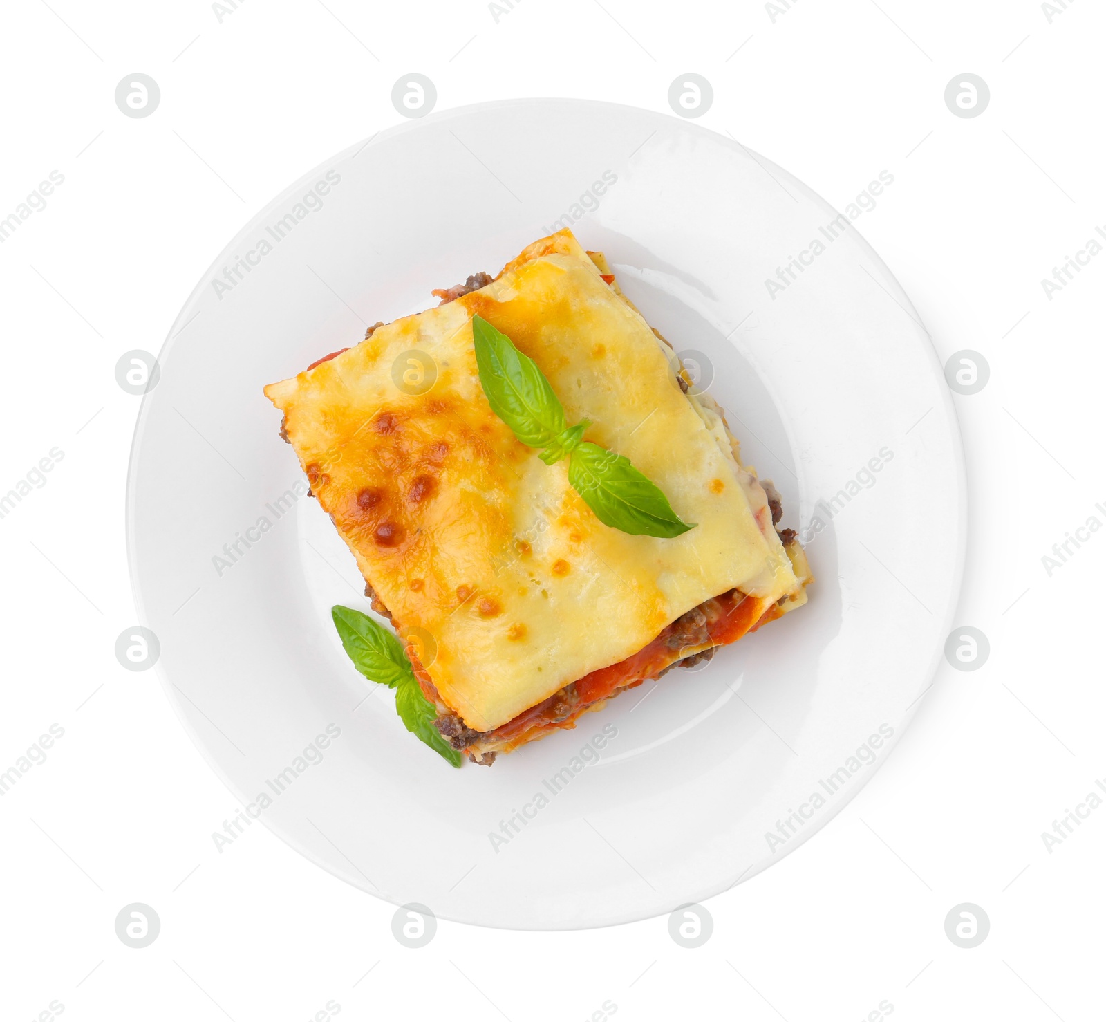 Photo of Piece of delicious cooked lasagna with basil isolated on white, top view