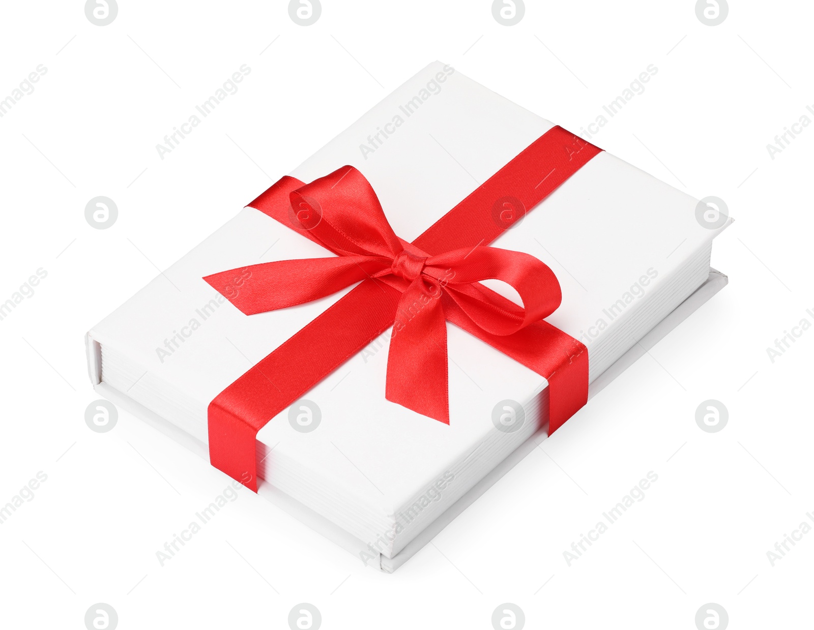 Photo of One book with red ribbon as gift isolated on white