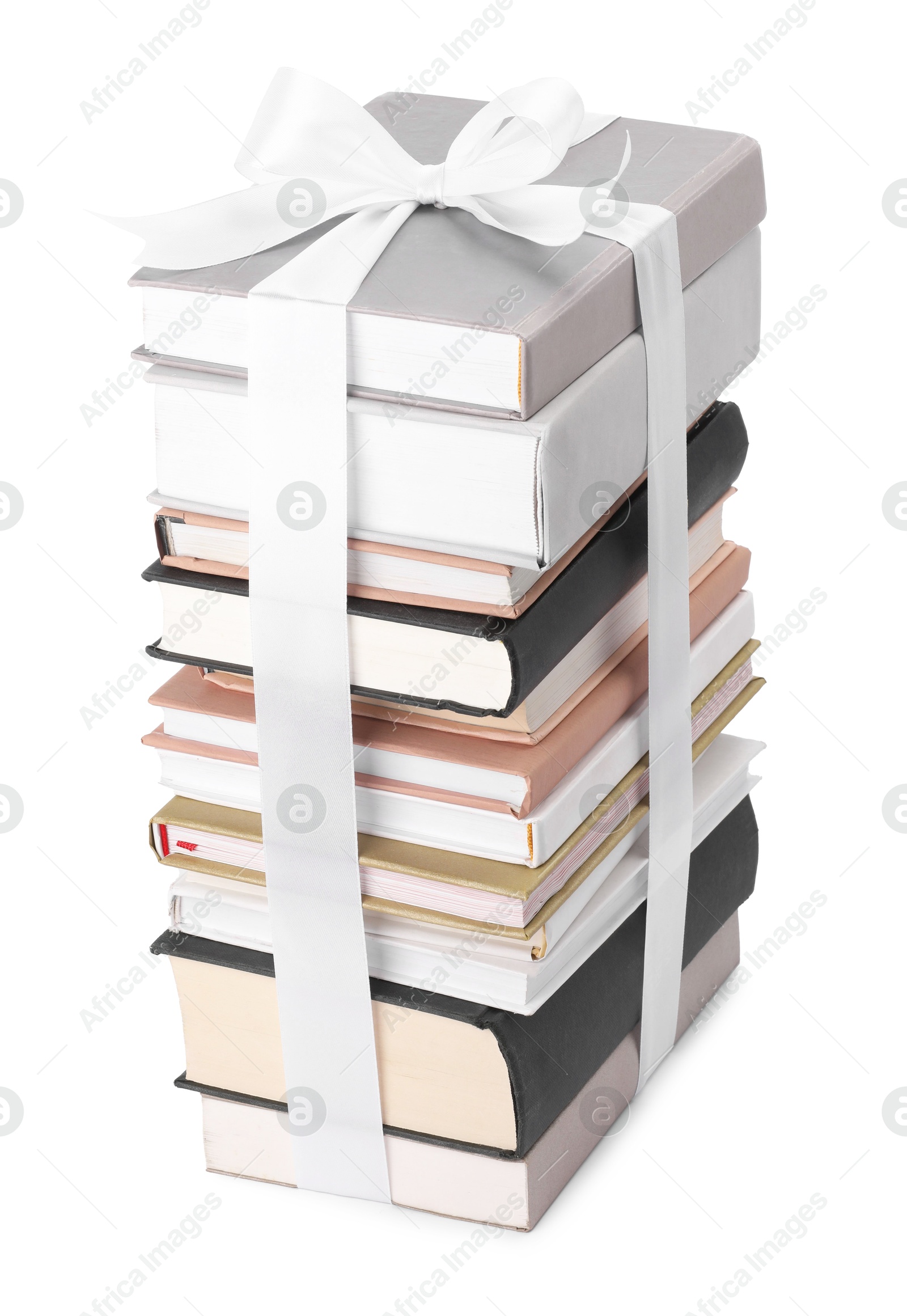 Photo of Stack of books with silk ribbon as gift isolated on white