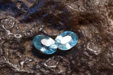 Photo of Beautiful shiny light blue gemstones on rock