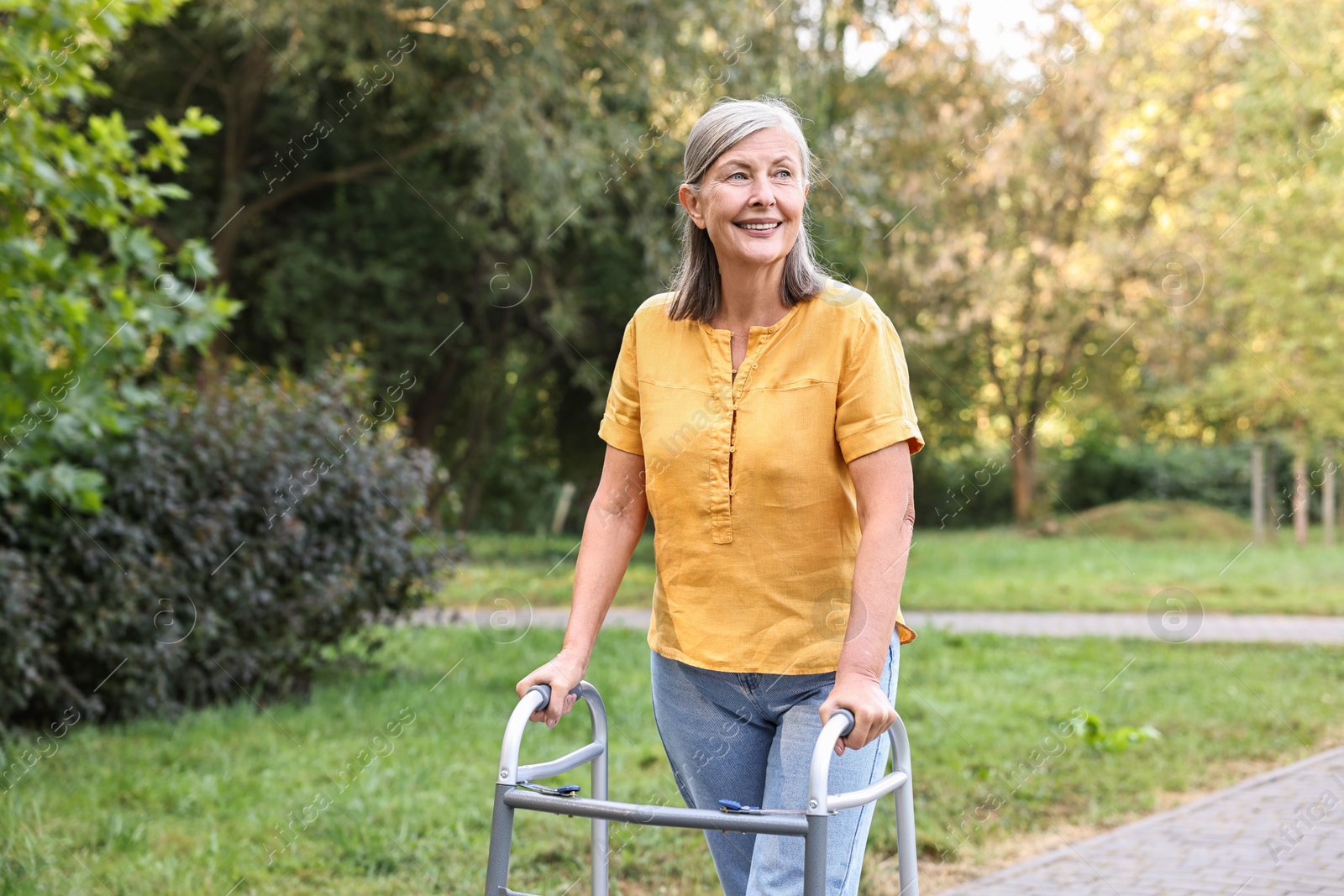 Photo of Senior woman with walking frame in park