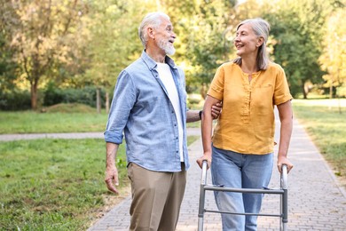 Photo of Senior couple with walking frame in park