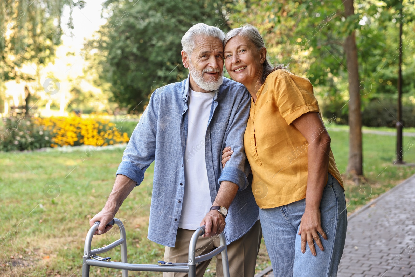 Photo of Senior couple with walking frame in park