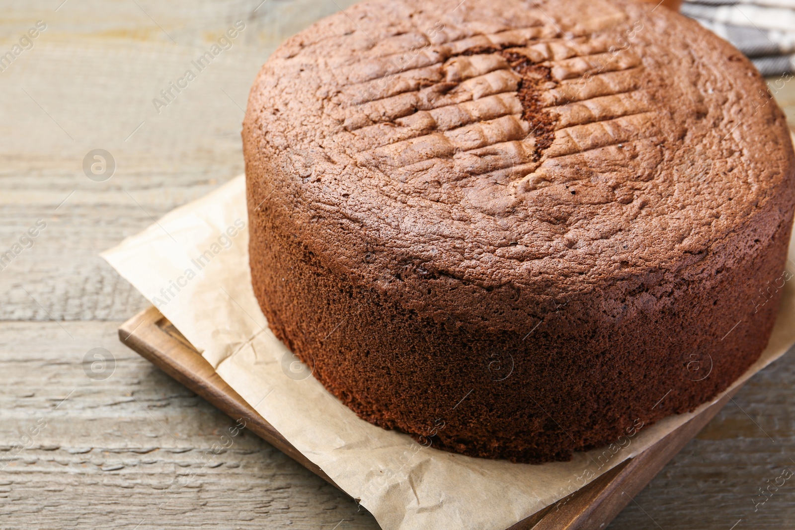 Photo of Tasty chocolate sponge cake on wooden table, closeup