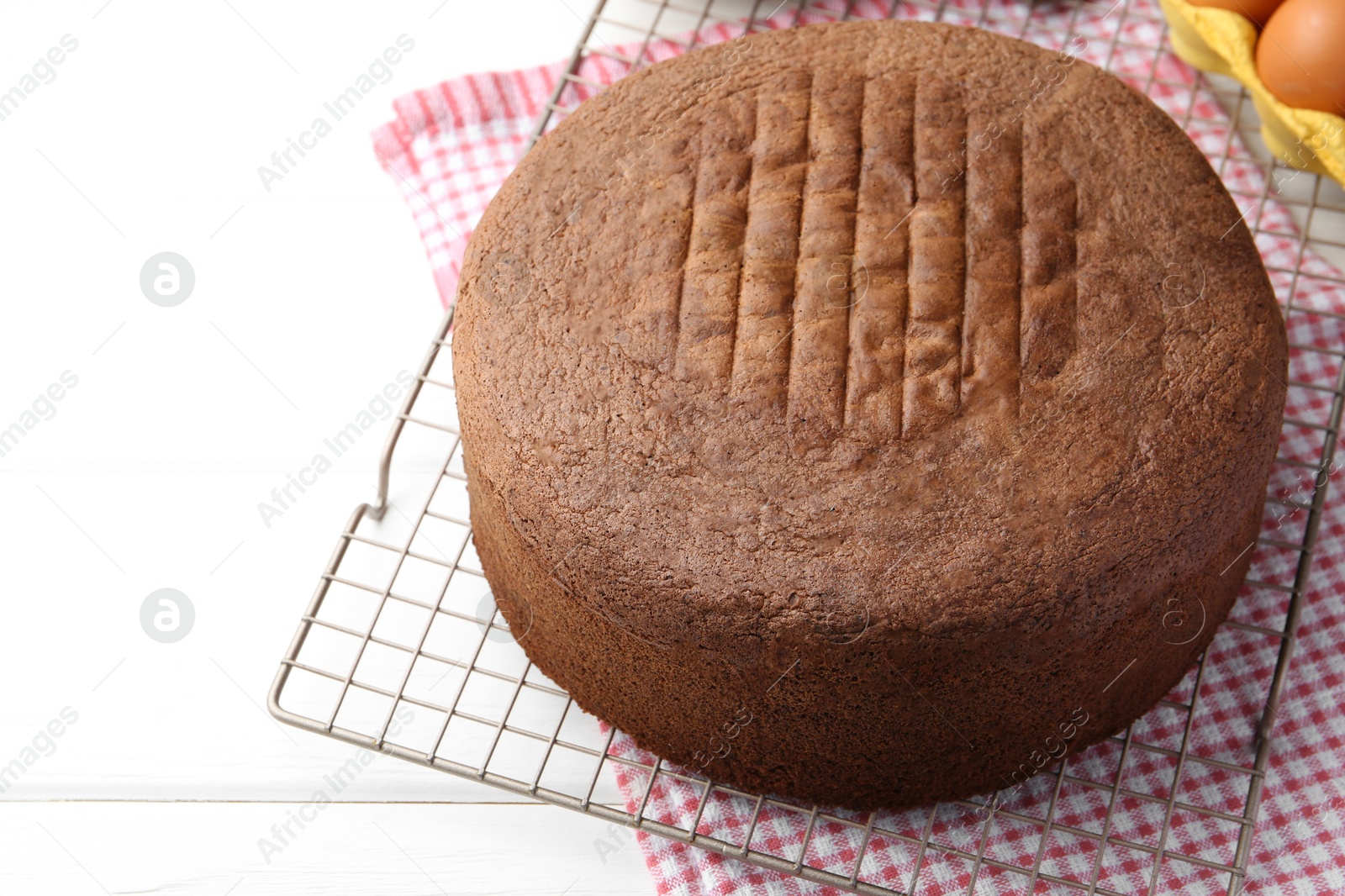 Photo of Tasty chocolate sponge cake on white wooden table, closeup