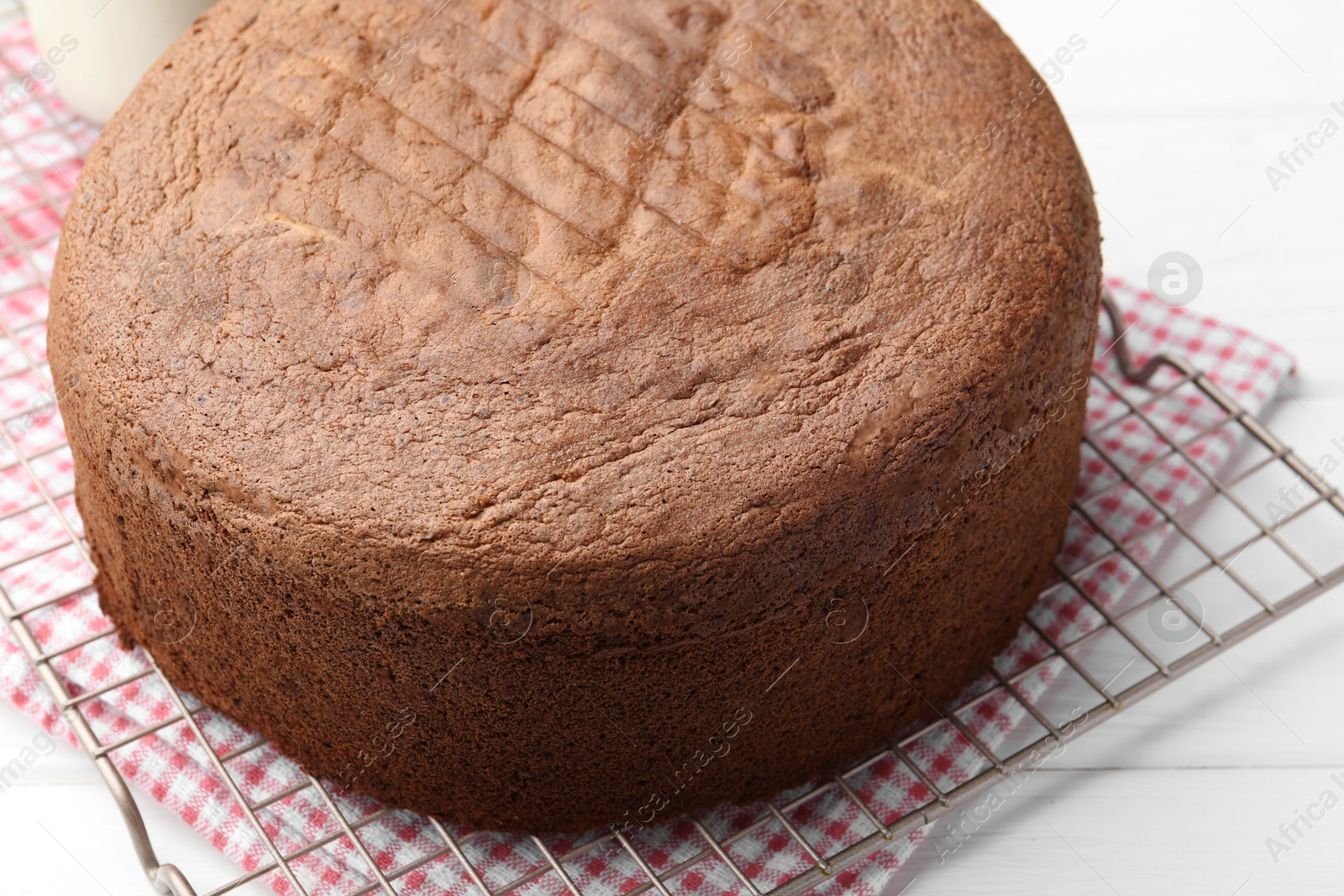 Photo of Tasty chocolate sponge cake on white wooden table, closeup