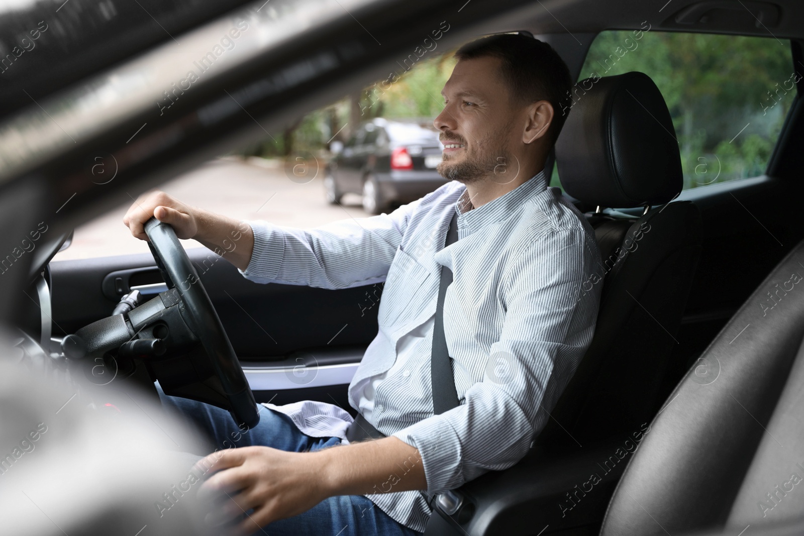 Photo of Man driving modern car, view through window