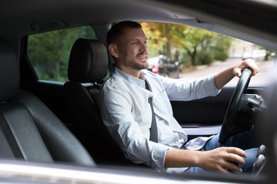 Photo of Man driving modern car, view through window