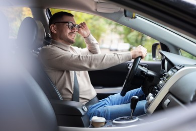 Photo of Man driving modern car, view through window