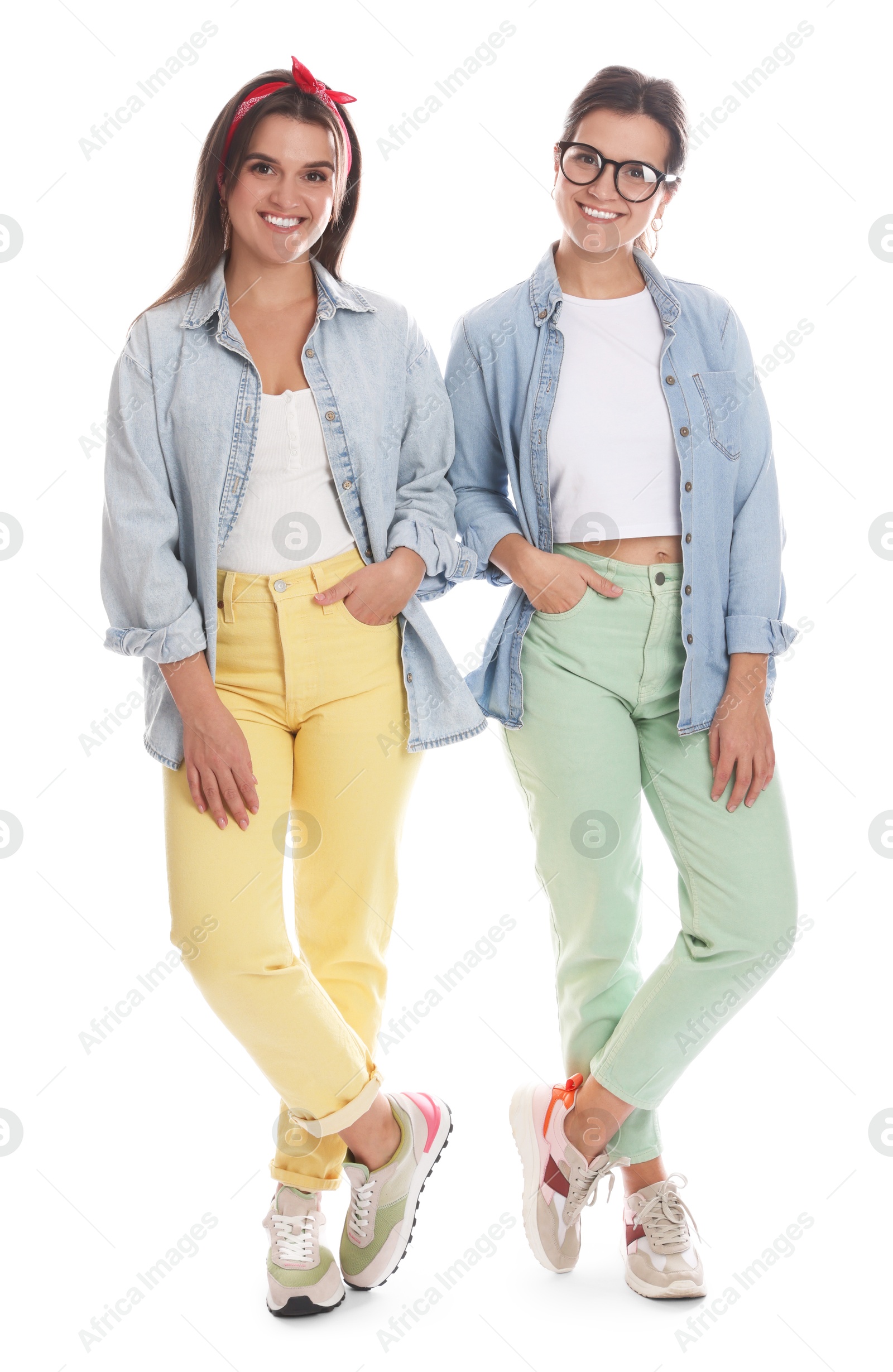 Photo of Portrait of beautiful twin sisters on white background