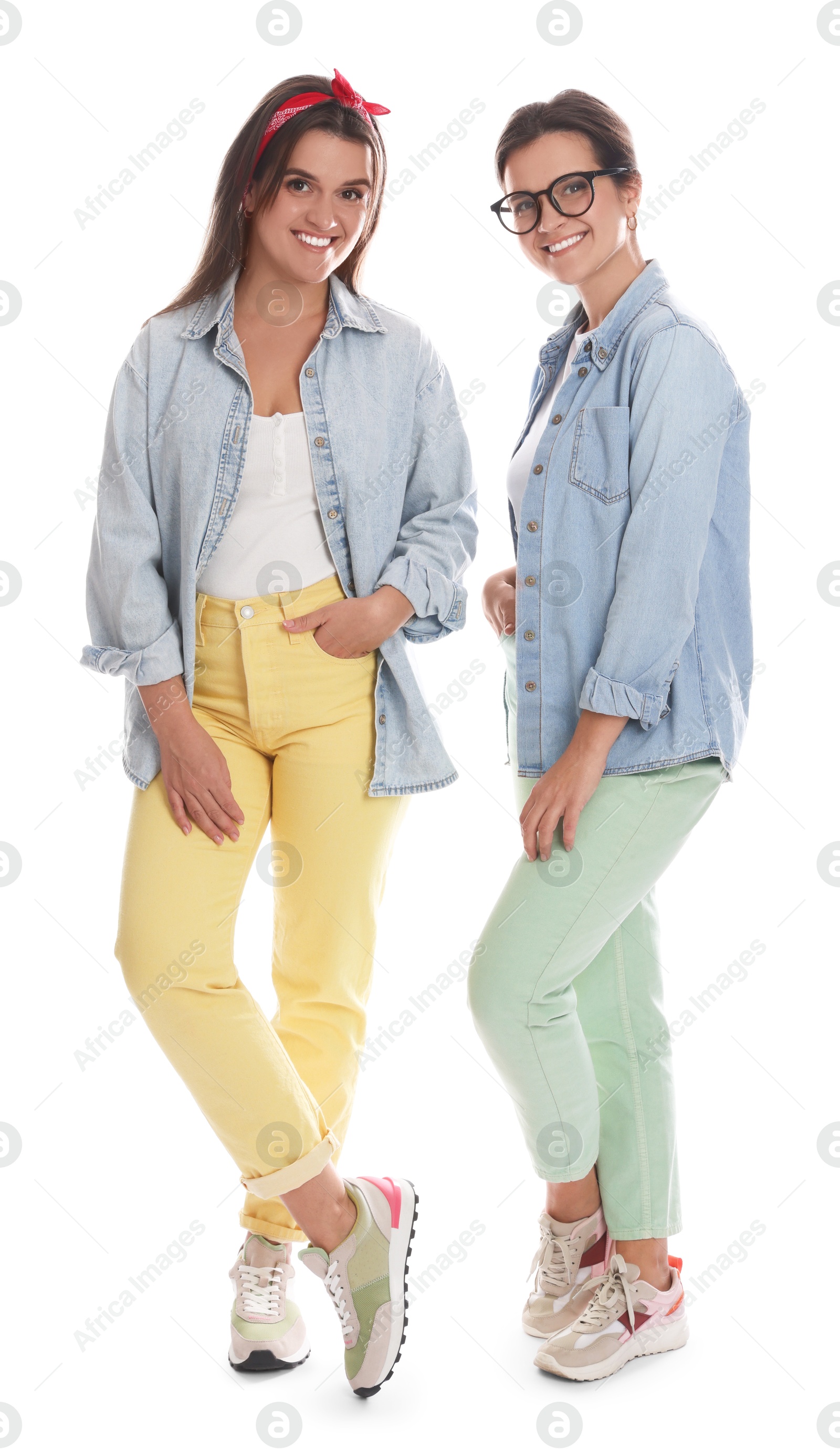 Photo of Portrait of beautiful twin sisters on white background