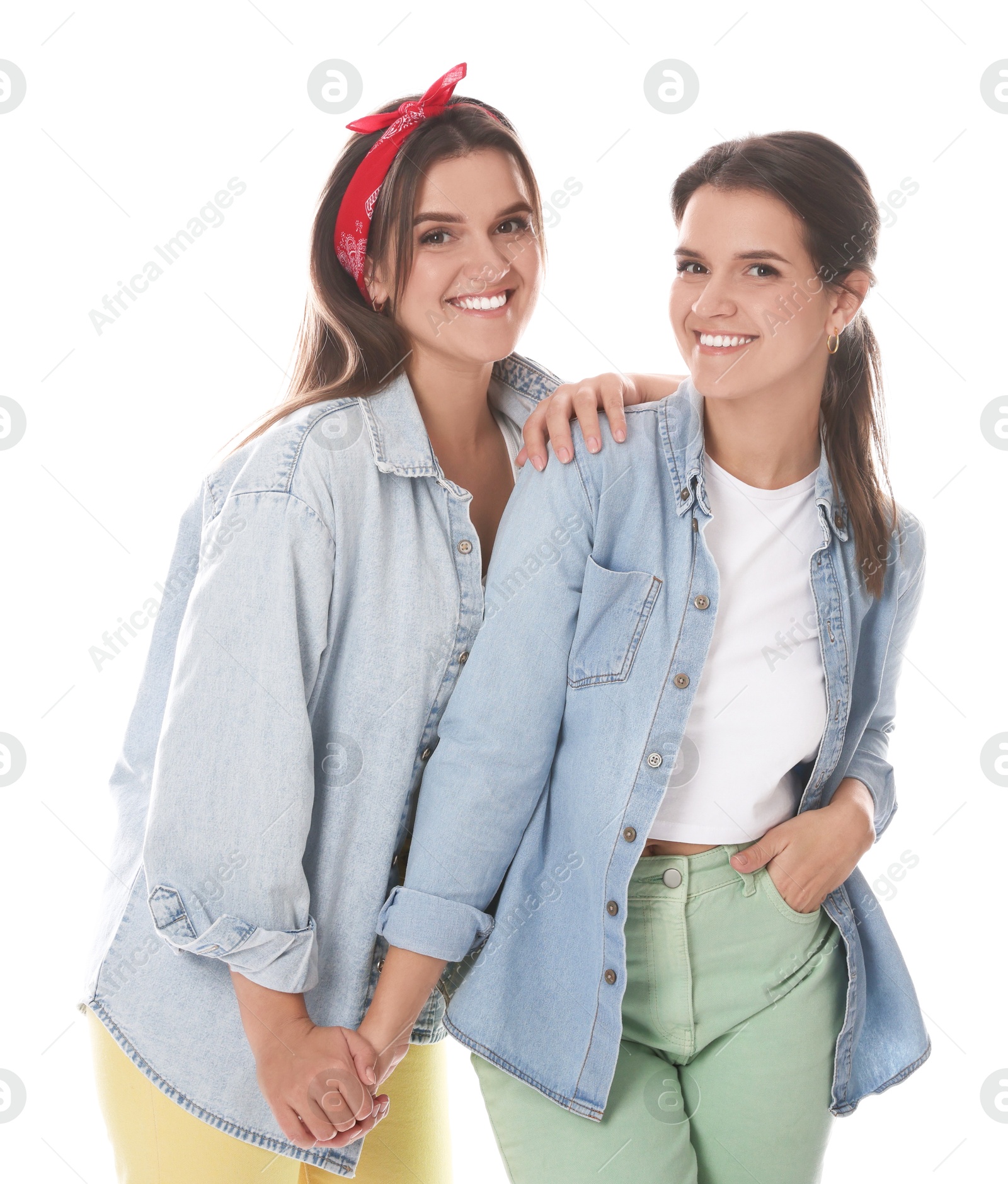 Photo of Portrait of beautiful twin sisters on white background