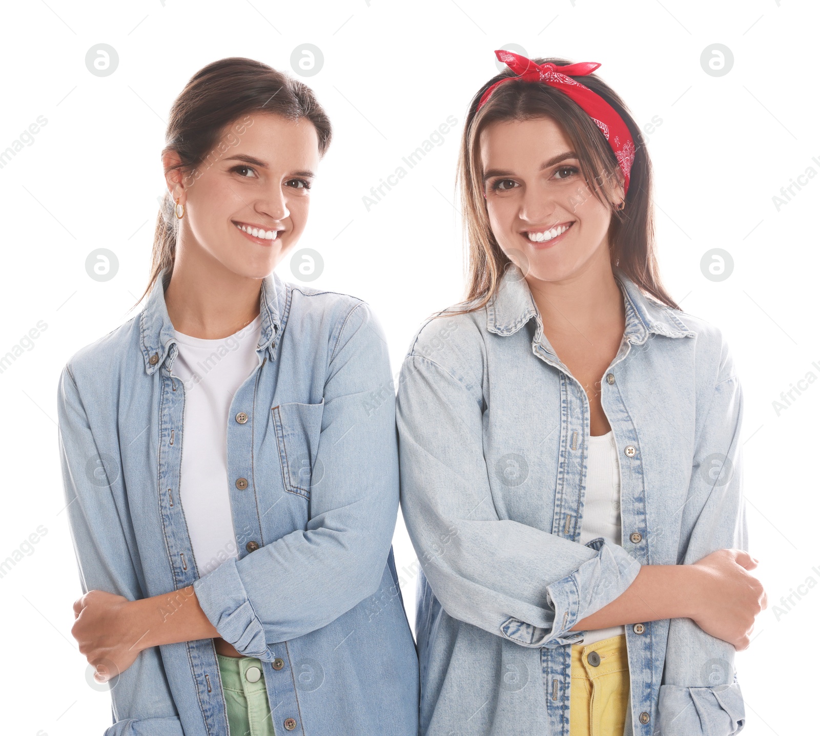 Photo of Portrait of beautiful twin sisters on white background