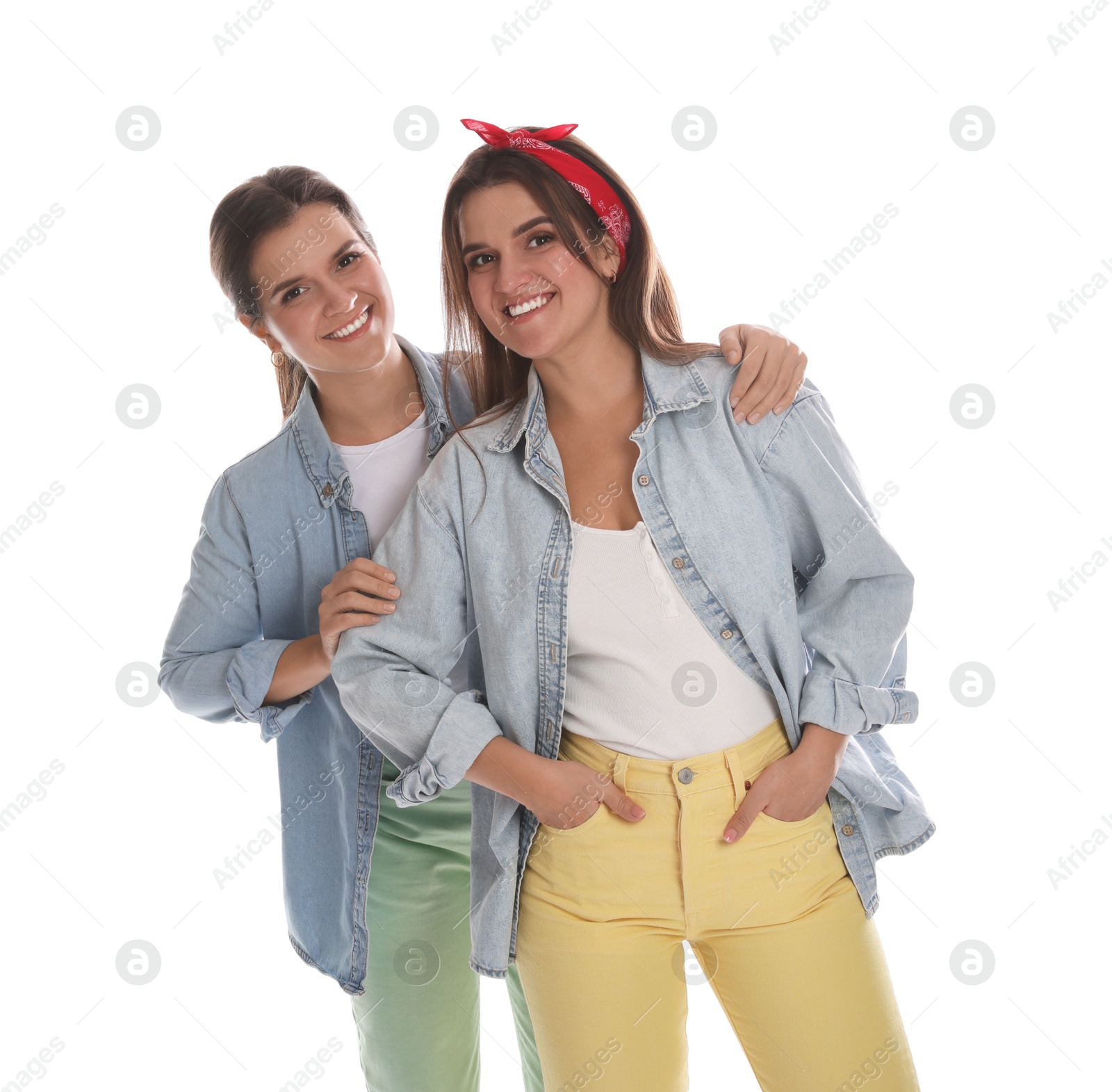 Photo of Portrait of beautiful twin sisters on white background