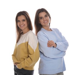 Photo of Portrait of beautiful twin sisters on white background