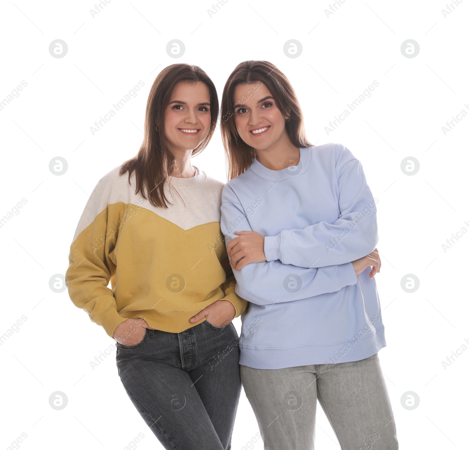 Photo of Portrait of beautiful twin sisters on white background