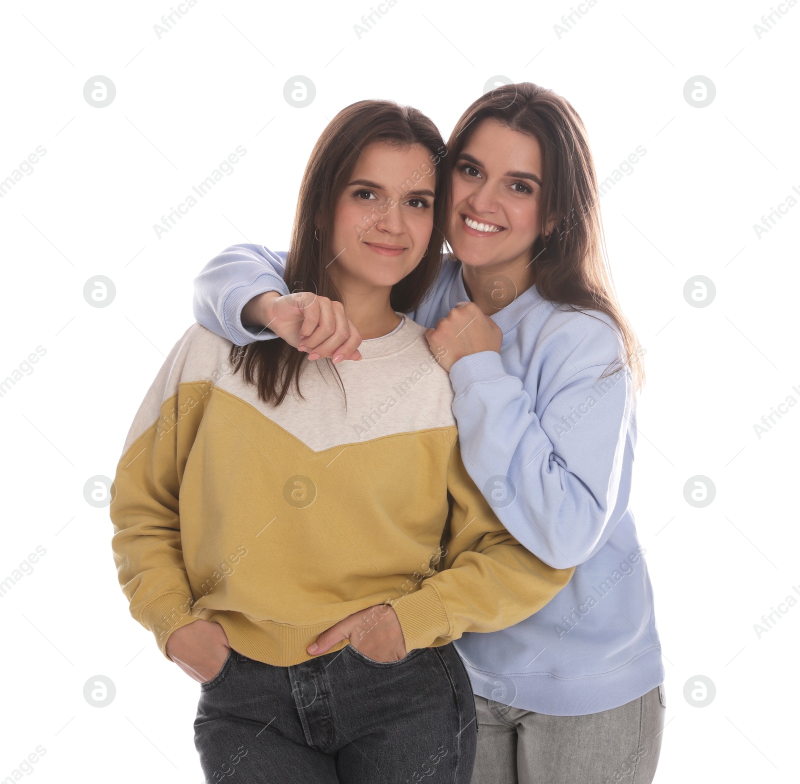 Photo of Portrait of beautiful twin sisters on white background