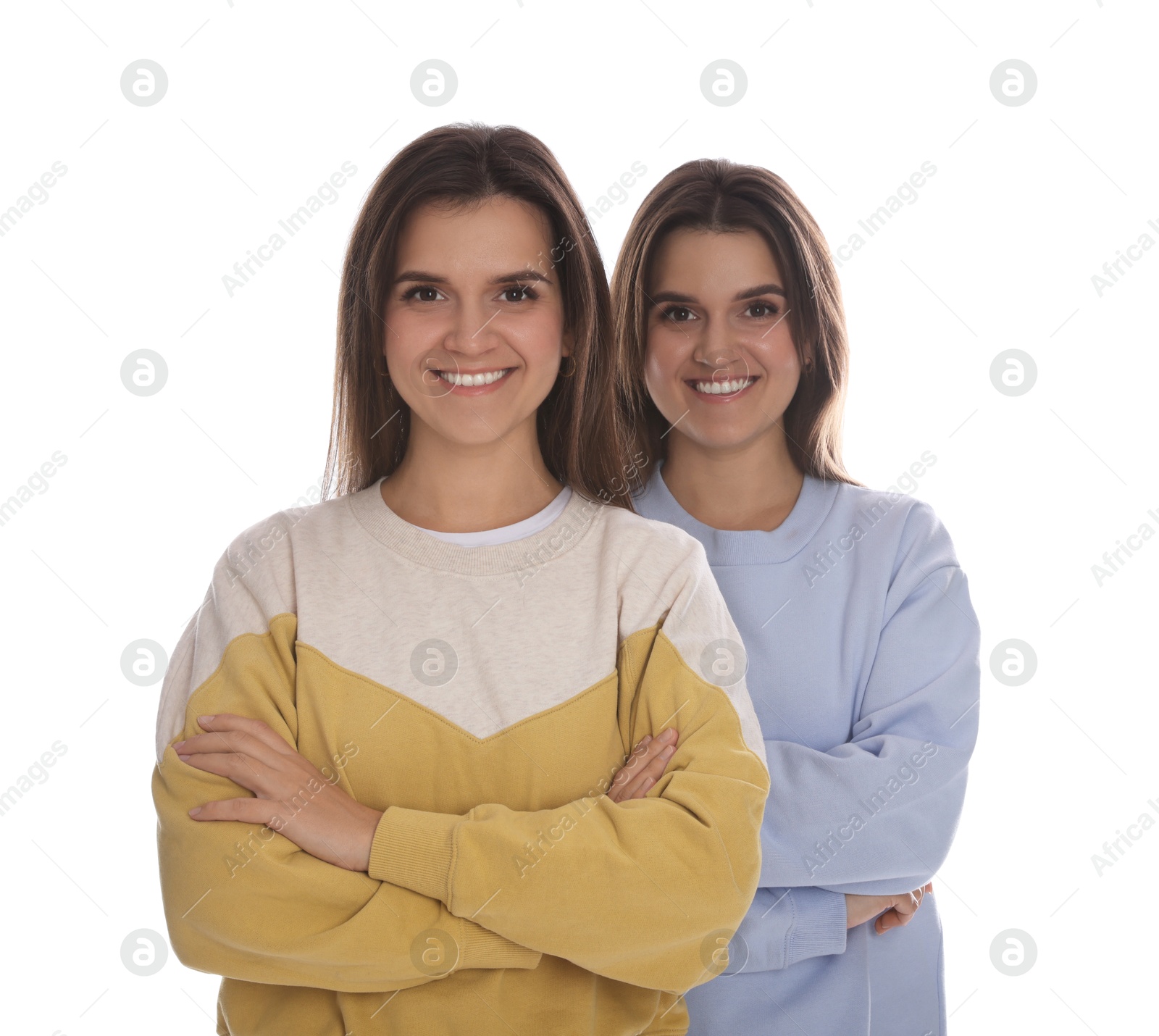 Photo of Portrait of beautiful twin sisters on white background