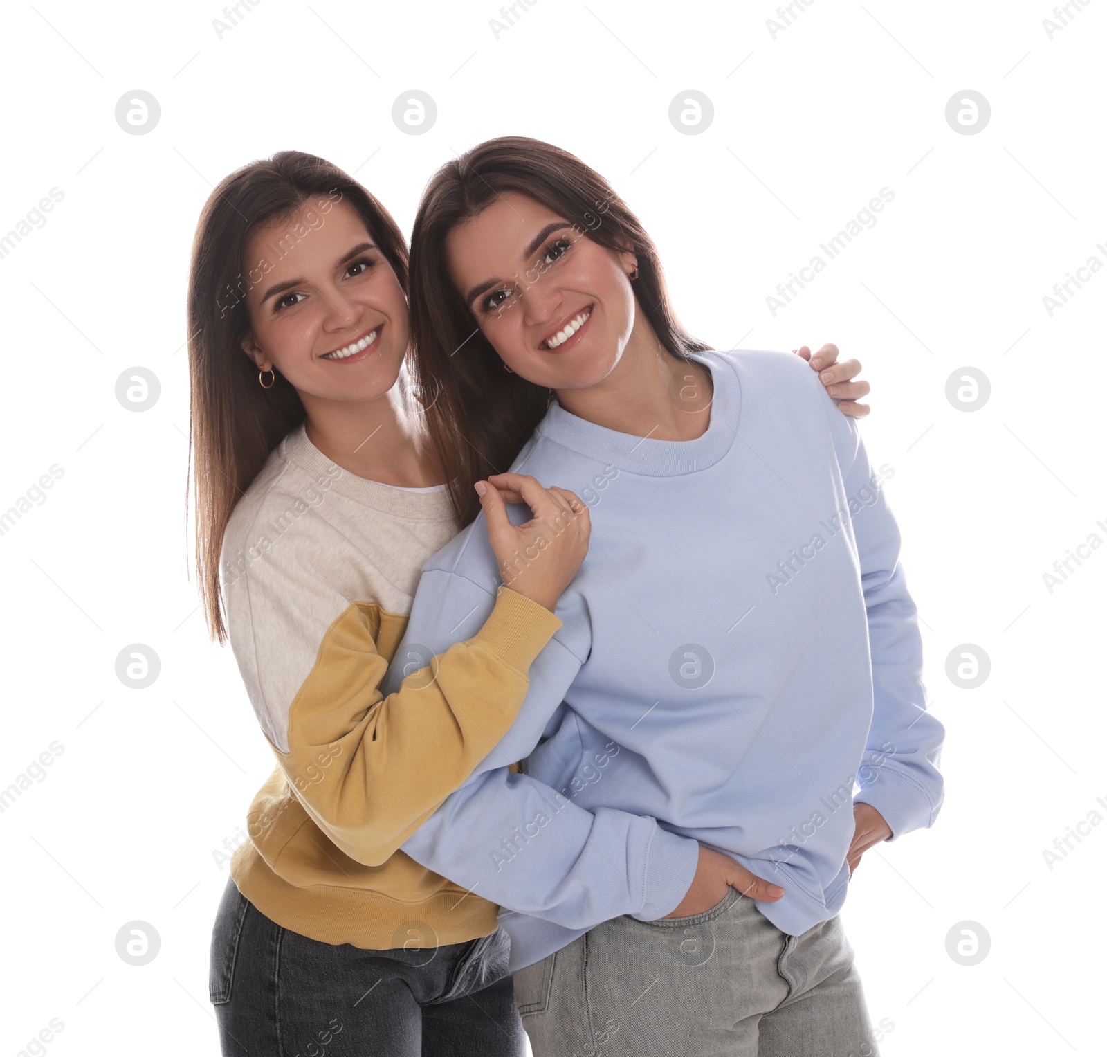 Photo of Portrait of beautiful twin sisters on white background