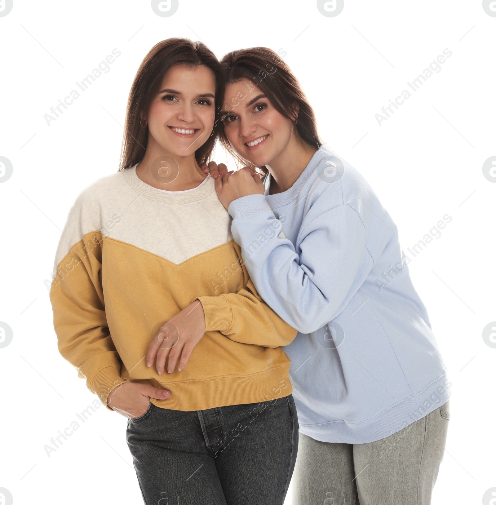 Photo of Portrait of beautiful twin sisters on white background