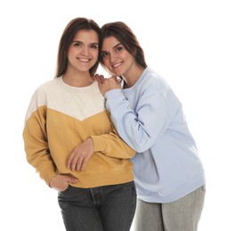 Photo of Portrait of beautiful twin sisters on white background