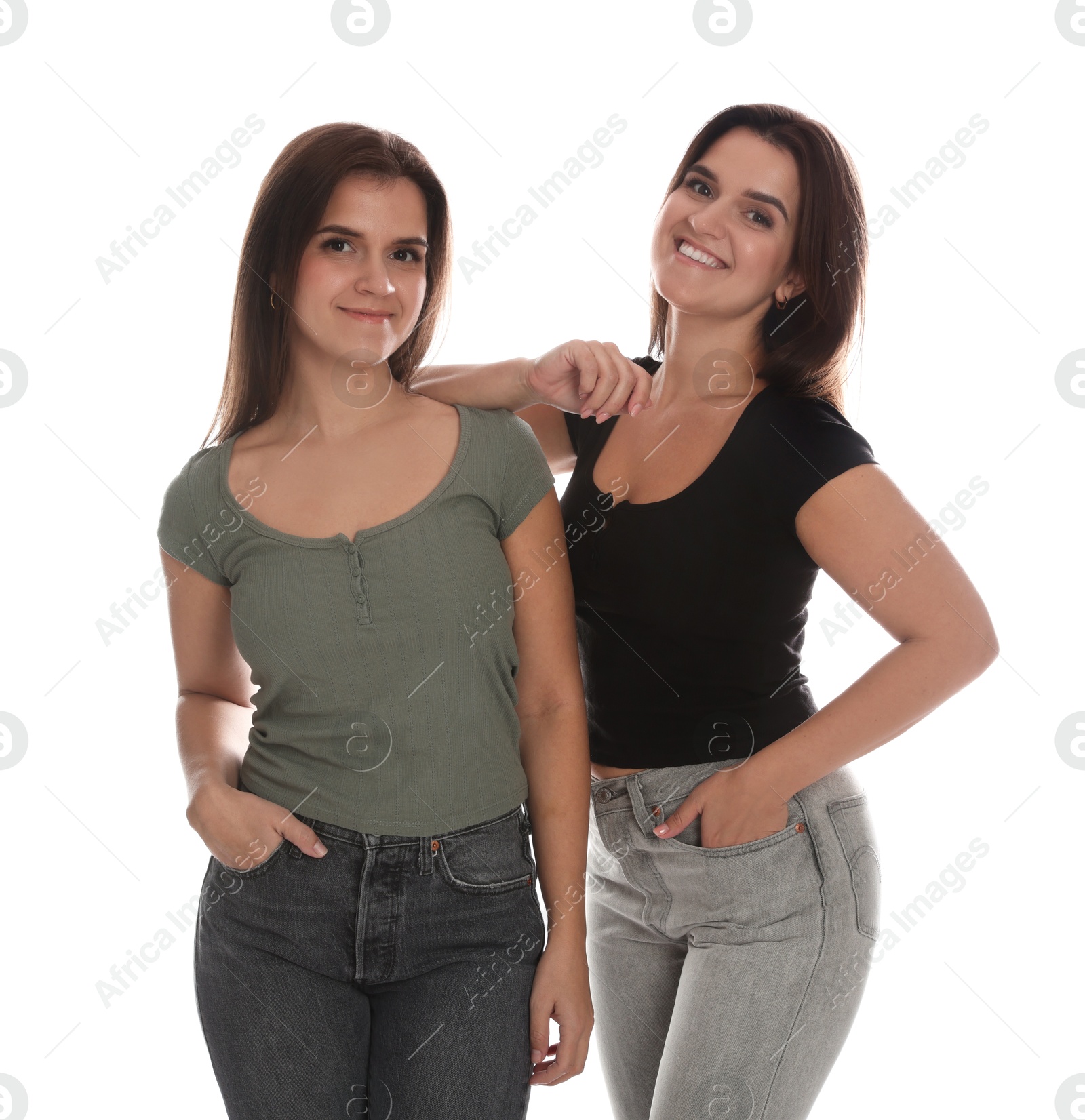 Photo of Portrait of beautiful twin sisters on white background