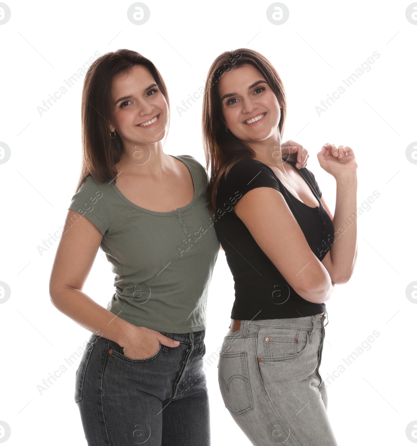 Photo of Portrait of beautiful twin sisters on white background