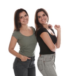 Photo of Portrait of beautiful twin sisters on white background