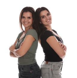 Photo of Portrait of beautiful twin sisters on white background