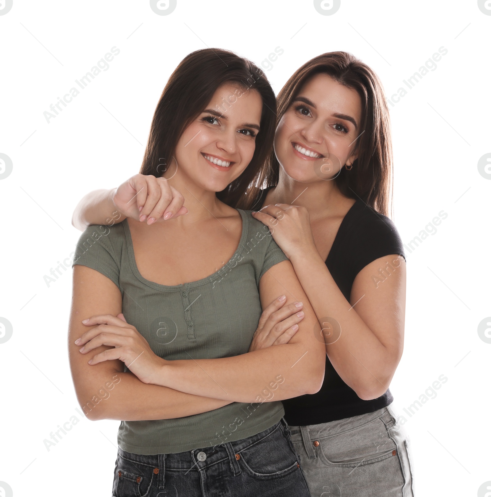 Photo of Portrait of beautiful twin sisters on white background