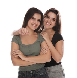 Photo of Portrait of beautiful twin sisters on white background