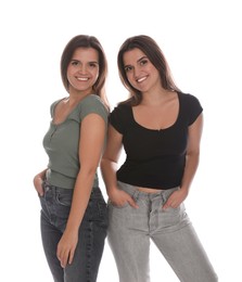 Photo of Portrait of beautiful twin sisters on white background