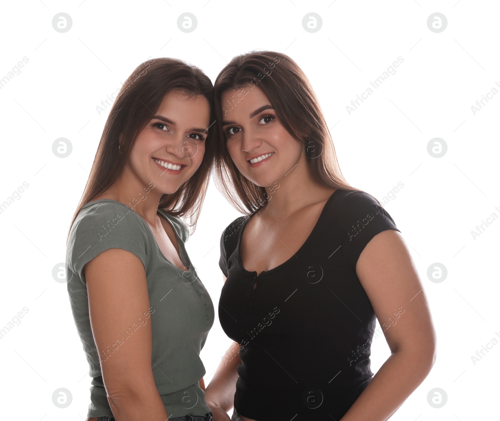 Photo of Portrait of beautiful twin sisters on white background