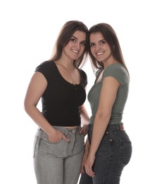 Photo of Portrait of beautiful twin sisters on white background