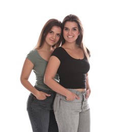 Photo of Portrait of beautiful twin sisters on white background