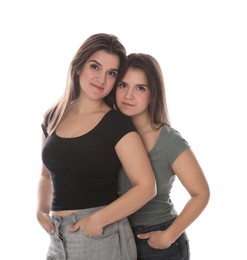 Photo of Portrait of beautiful twin sisters on white background