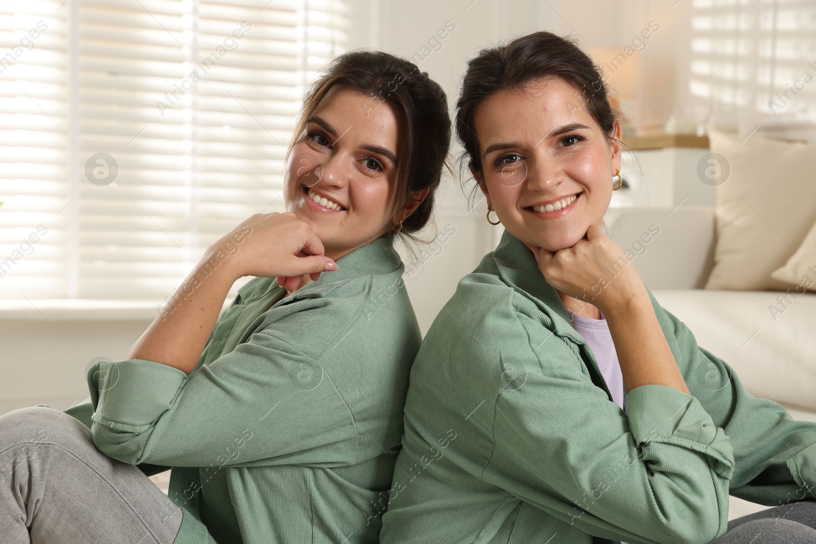 Photo of Portrait of beautiful twin sisters at home