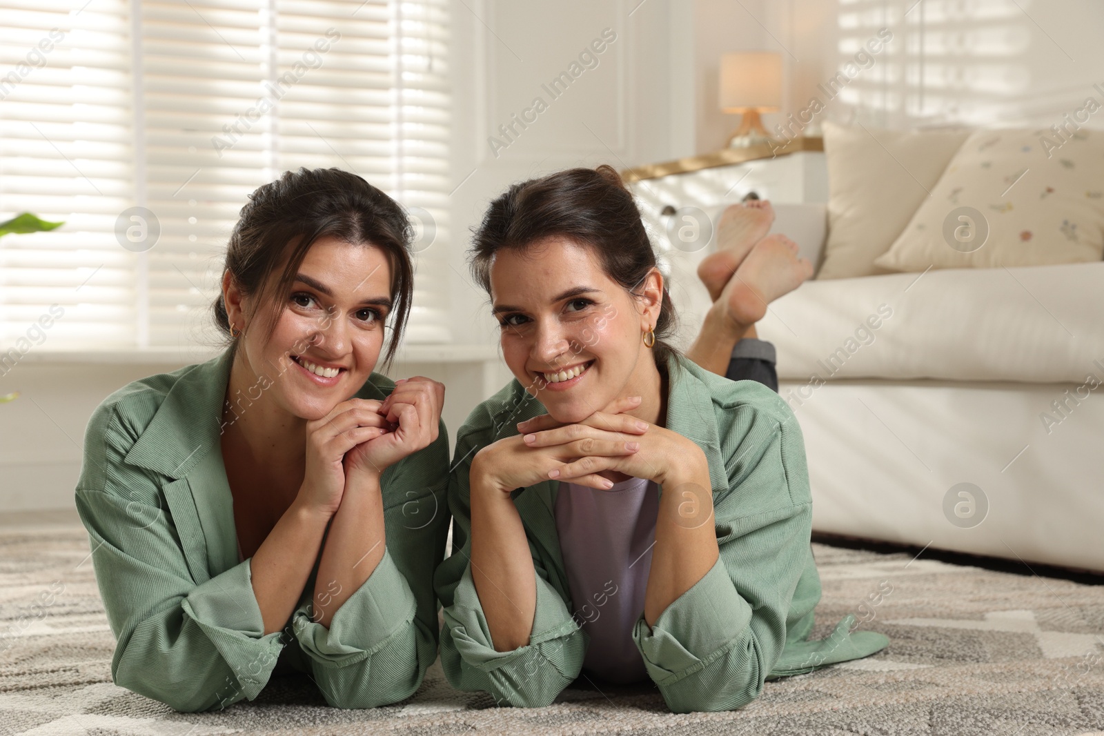 Photo of Portrait of beautiful twin sisters at home