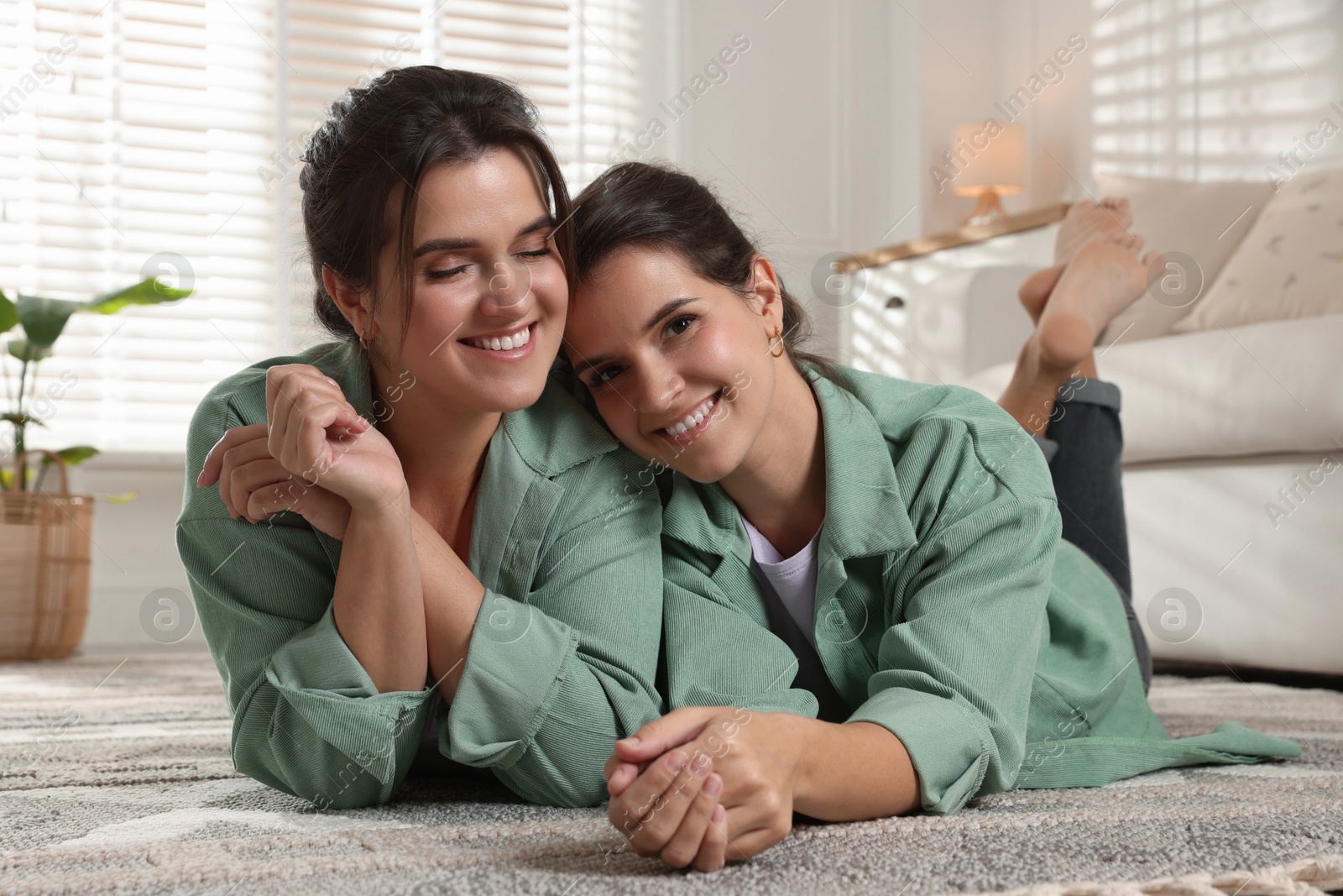 Photo of Portrait of beautiful twin sisters at home