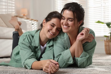 Photo of Portrait of beautiful twin sisters at home