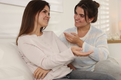 Photo of Beautiful twin sisters spending time together at home