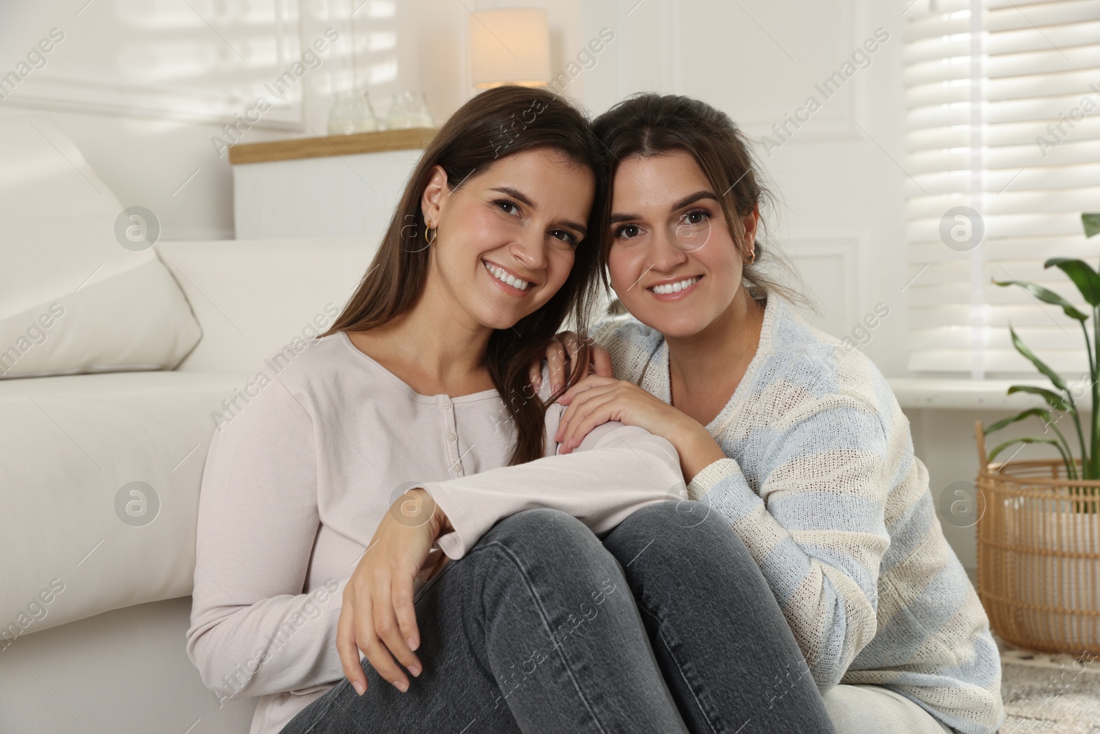 Photo of Portrait of beautiful twin sisters at home