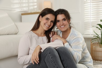 Photo of Portrait of beautiful twin sisters at home