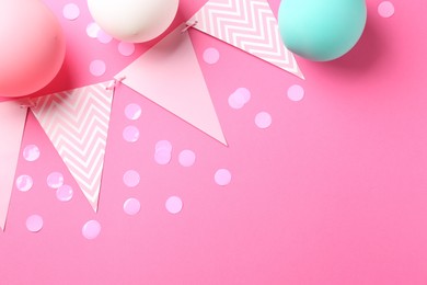 Photo of Confetti, garland and air balloons on pink background, flat lay. Space for text