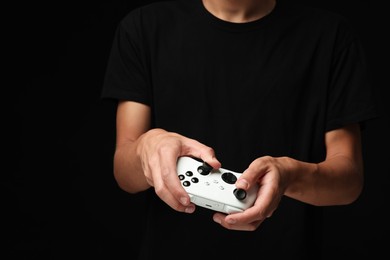 Photo of Man with controller on black background, closeup